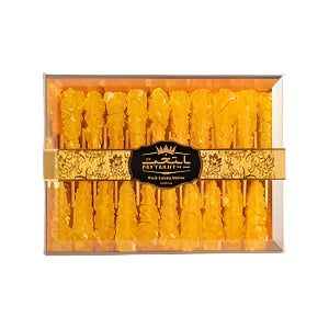 Box of 12 saffron yellow rock candy stirrers in a clear Paytakht packaging, offering a sweet and vibrant touch for stirring drinks or desserts.